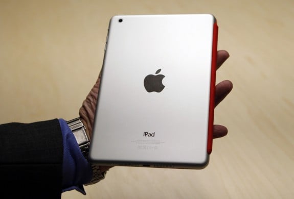 A visitor looks over the new iPad mini at an Apple event in San Jose