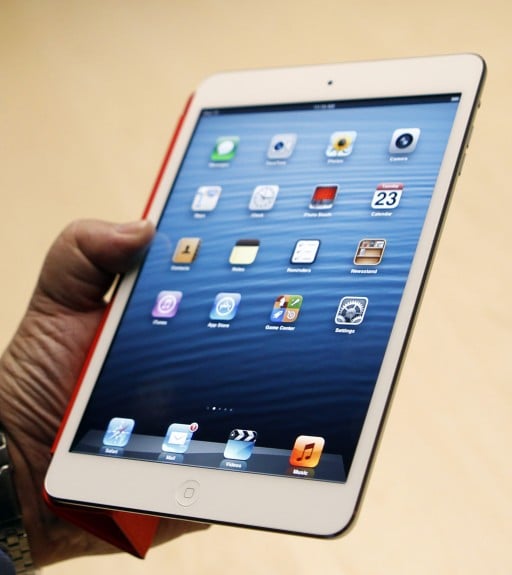 A visitor looks over the new iPad mini at an Apple event in San Jose