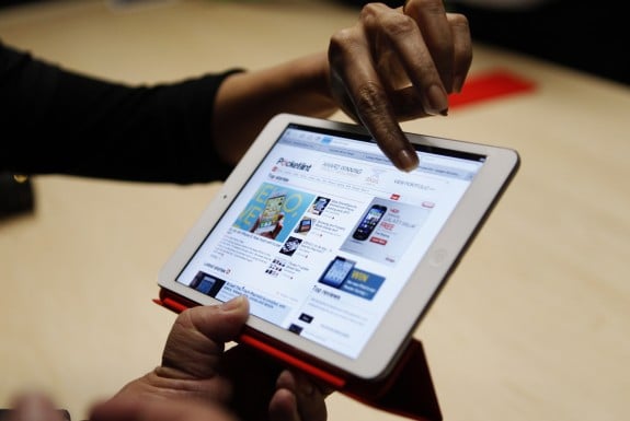 Visitors look over the new iPad mini at an Apple event in San Jose