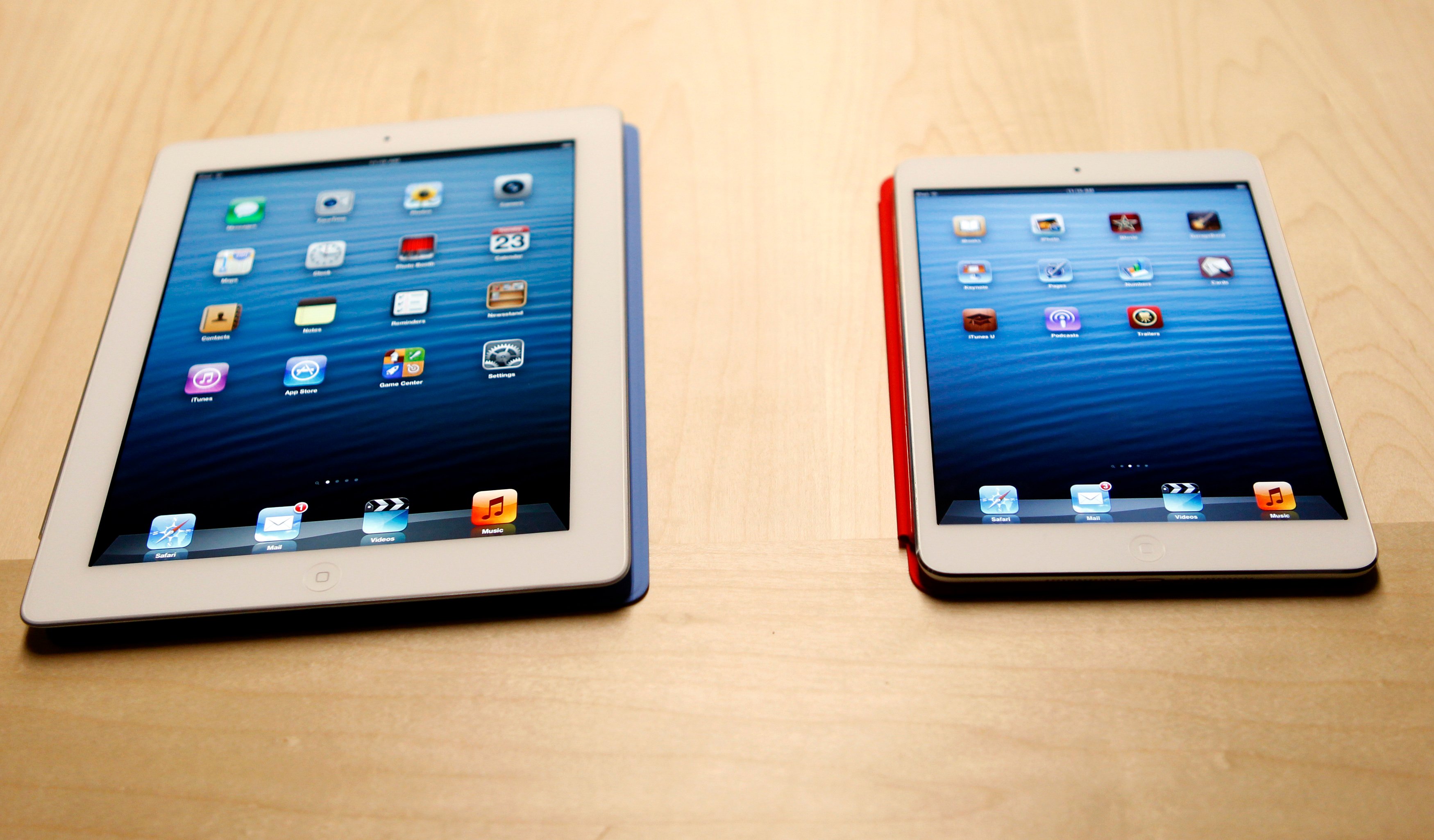 The new iPad mini is shown next to a full sized model at an Apple event in San Jose