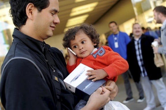 Kai Lanier plays with his dad's newly purchased iPhone 5 outside an Apple Store in San Francisco