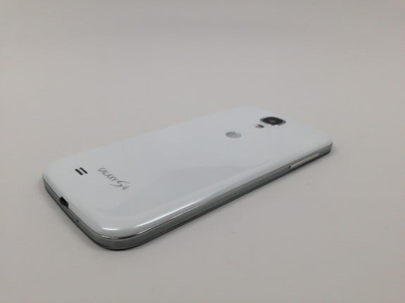 The Galaxy S4 wireless charger slips inside the back, so cases still work. 