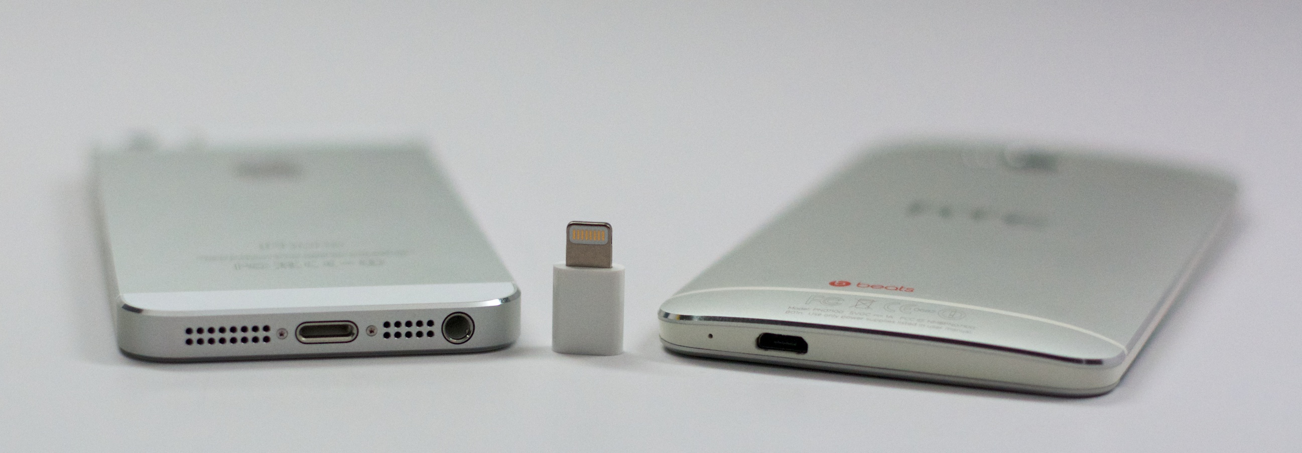 The iPhone 5s uses a Lightning connection and the HTC One uses a Micro USB, but with an adapter the same cable can charge both.