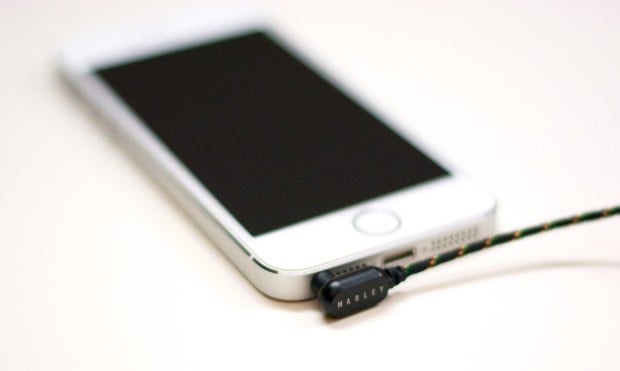 An L shaped adapter fits most cases and hugs the iPhone 5s' edge. 