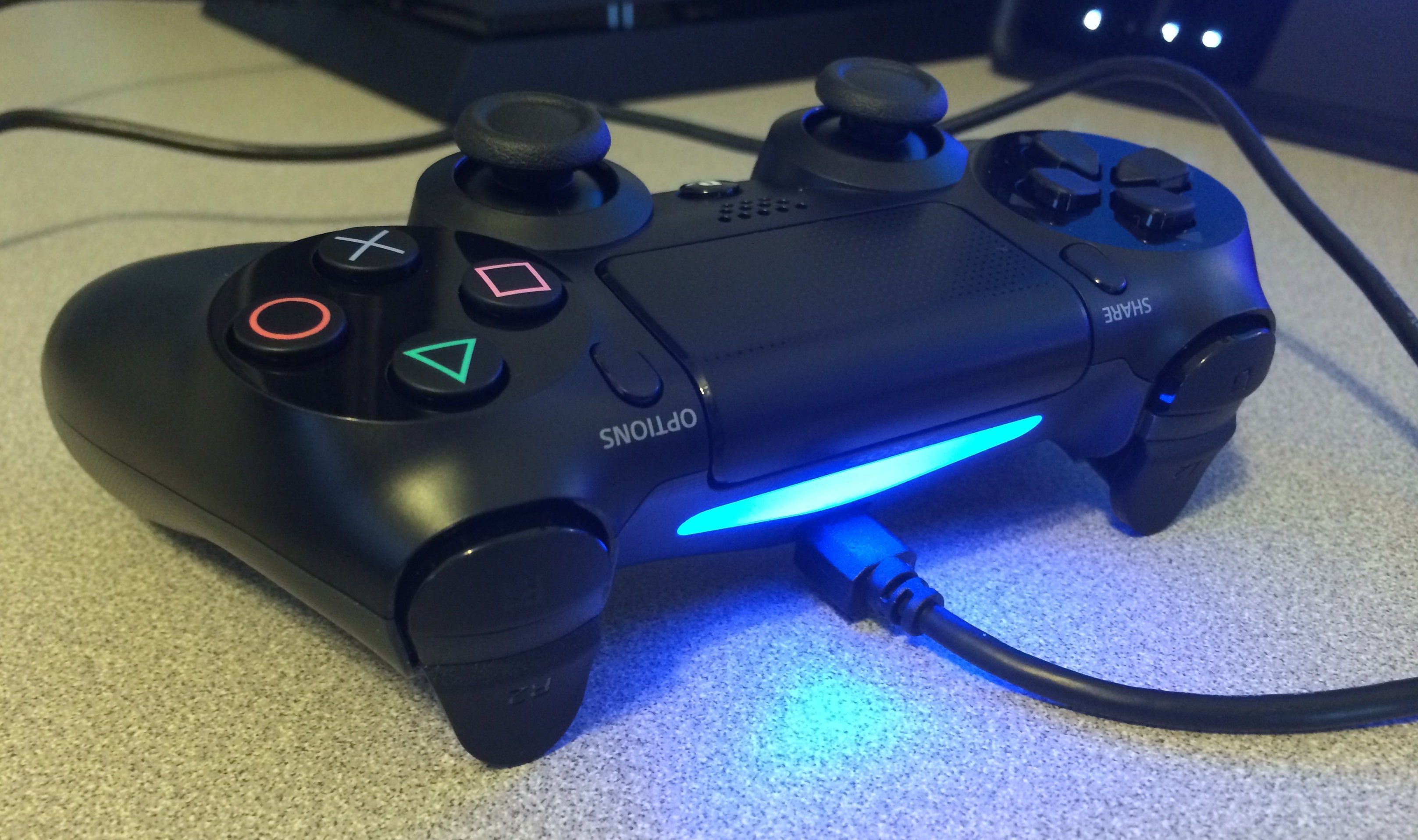 Connect the PS4 DualShock 4 controller with the included cable.