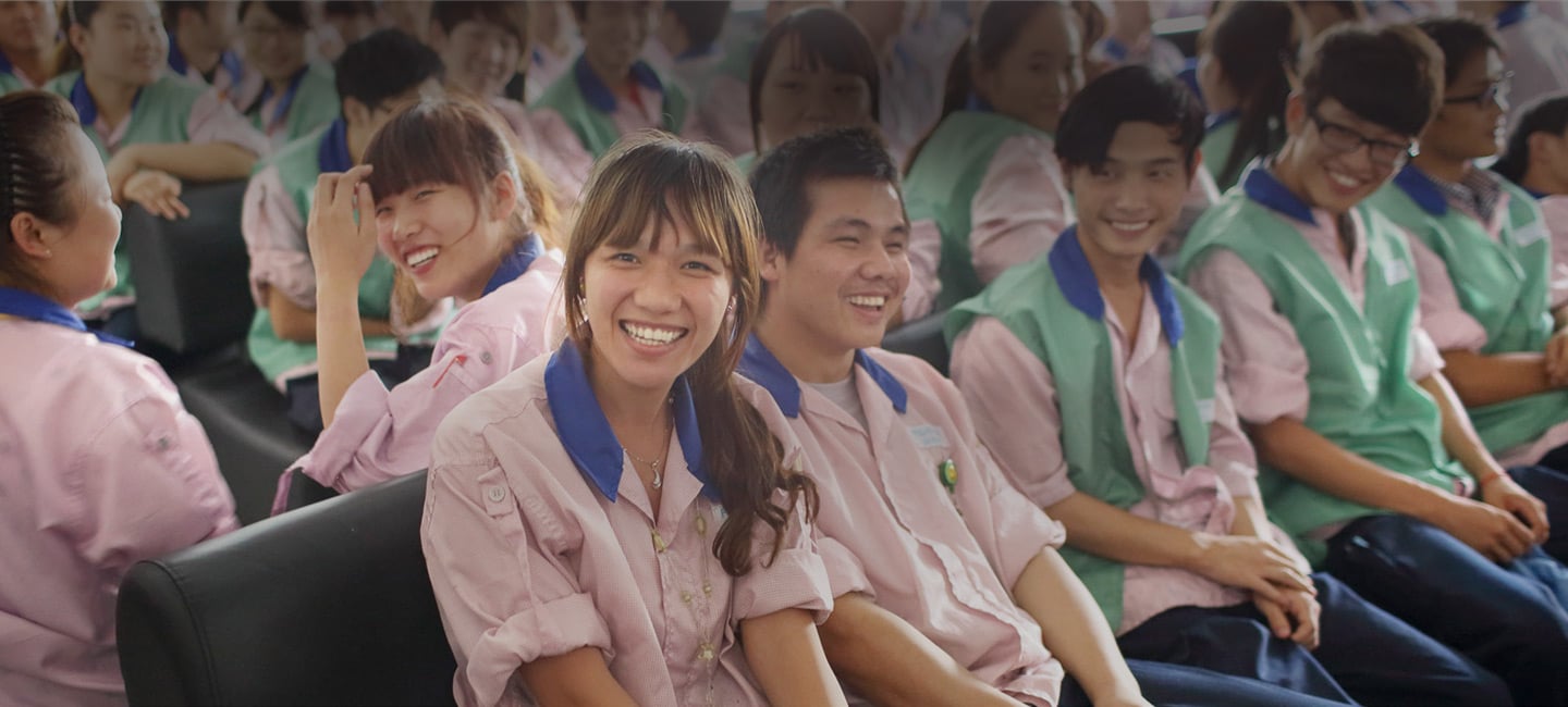 Workers relax during a break at a factory in Shanghai, China - Apple
