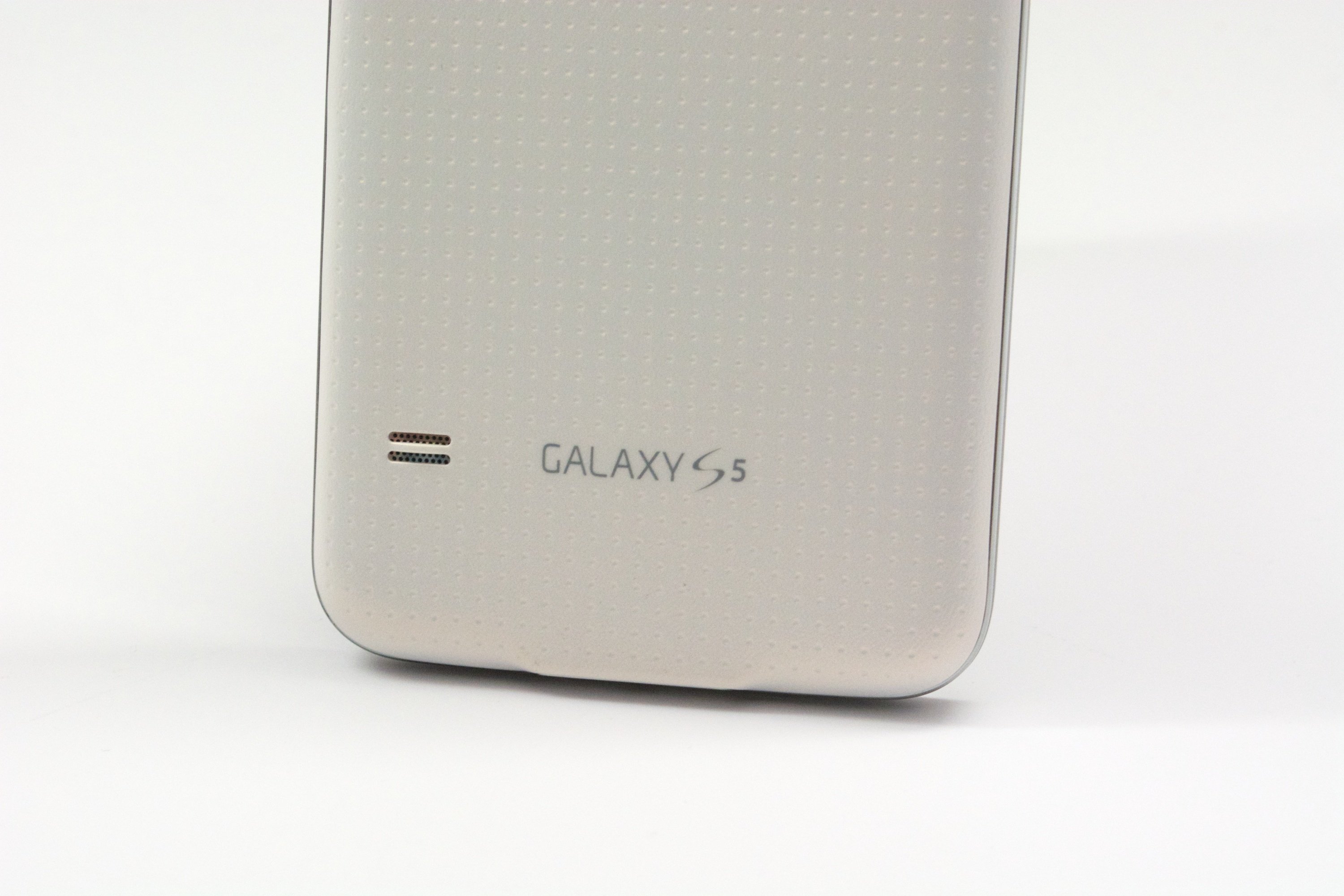 The Galaxy S5 design includes a soft touch dimpled back.