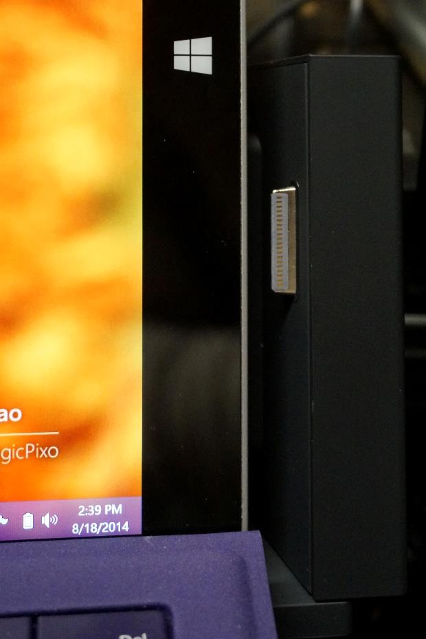 This shows the Surface Pro 3 Docking Station opened. Notice the charging connector ready to insert itself into the side of the Surface Pro 3.
