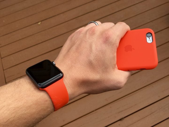 The official Apple iPhone 6s silicone case matches the Apple Watch band in orange.