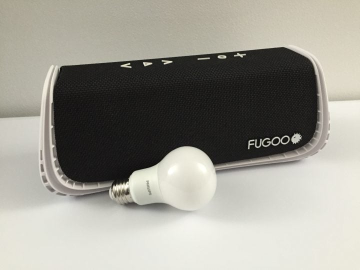 The Fugoo XL next to a standard household light bulb.