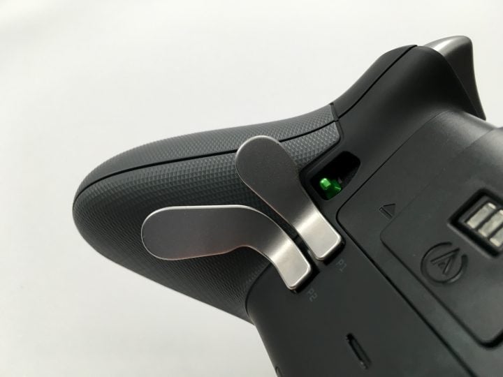 Paddles on the bottom of the controller let you press buttons without taking fingers off the sticks. 