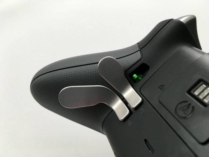 Paddles on the bottom of the controller let you press buttons without taking fingers off the sticks.