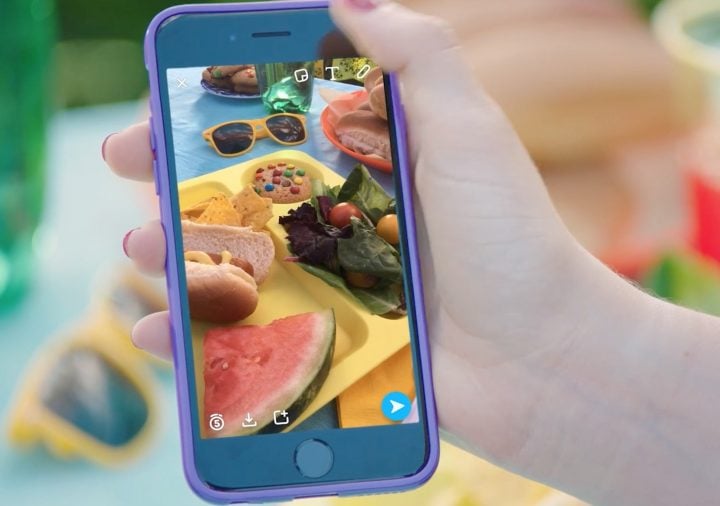 Tap on the sticker button in Snapchat.