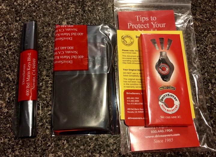The flash drive, retuned phone and materials about the DriveSavers data recovery.