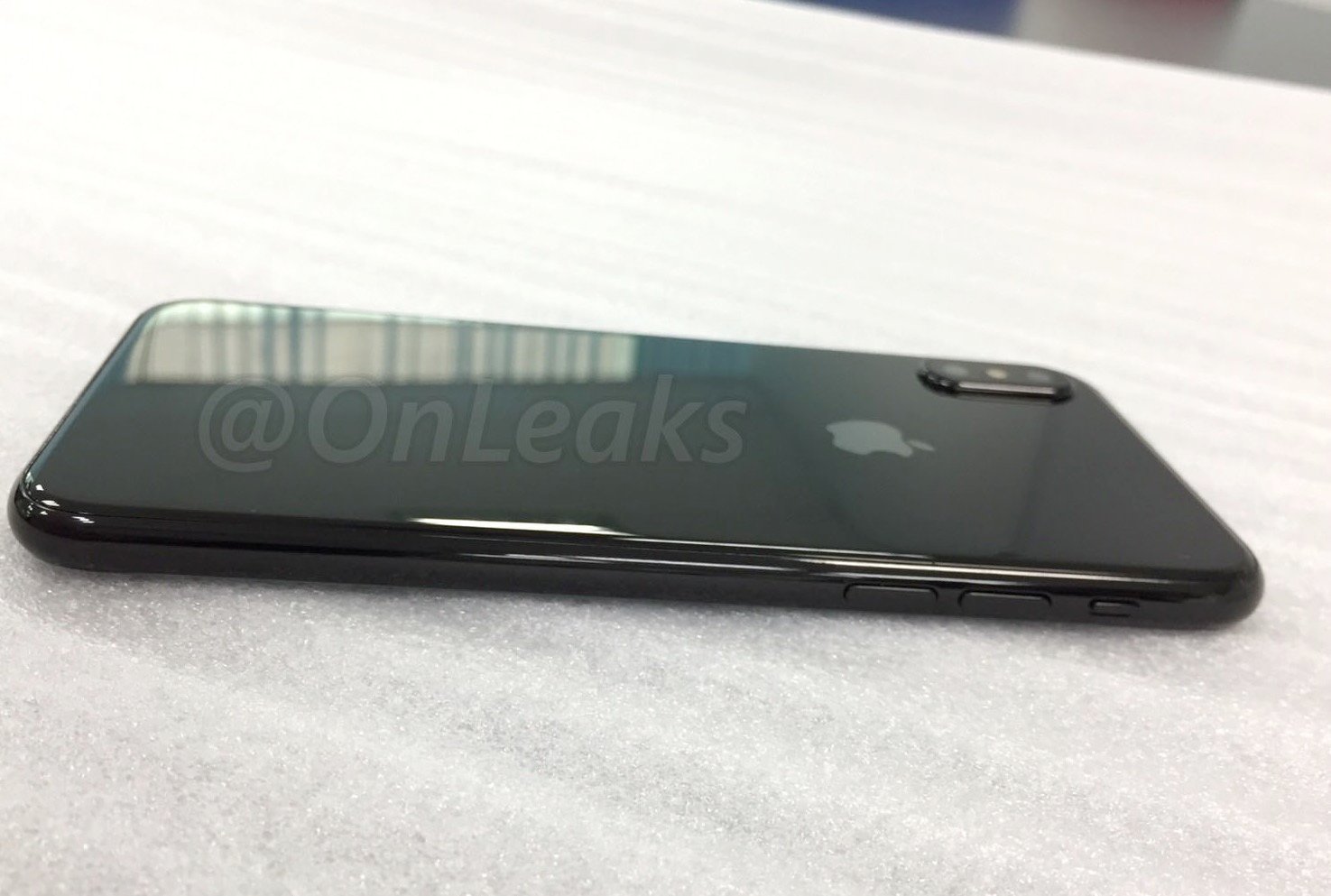 A glass back with a new camera design on an iPhone 8 dummy unit.