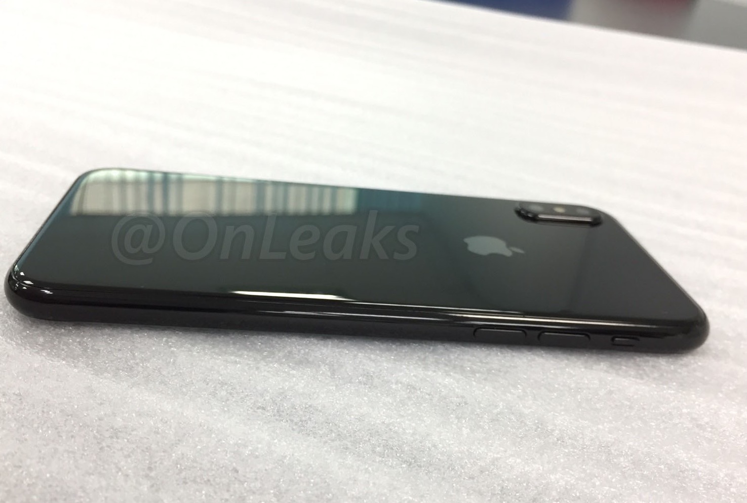 A glass back with a new camera design on an iPhone 8 dummy unit.