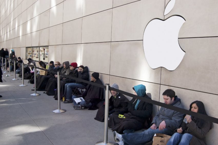 Users wait in line to buy a new iPhone. jessicakirsh / Shutterstock.com