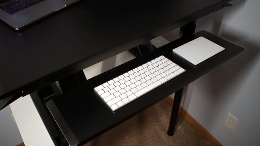 The keyboard tray adjusts independently and includes a negative tilt option.