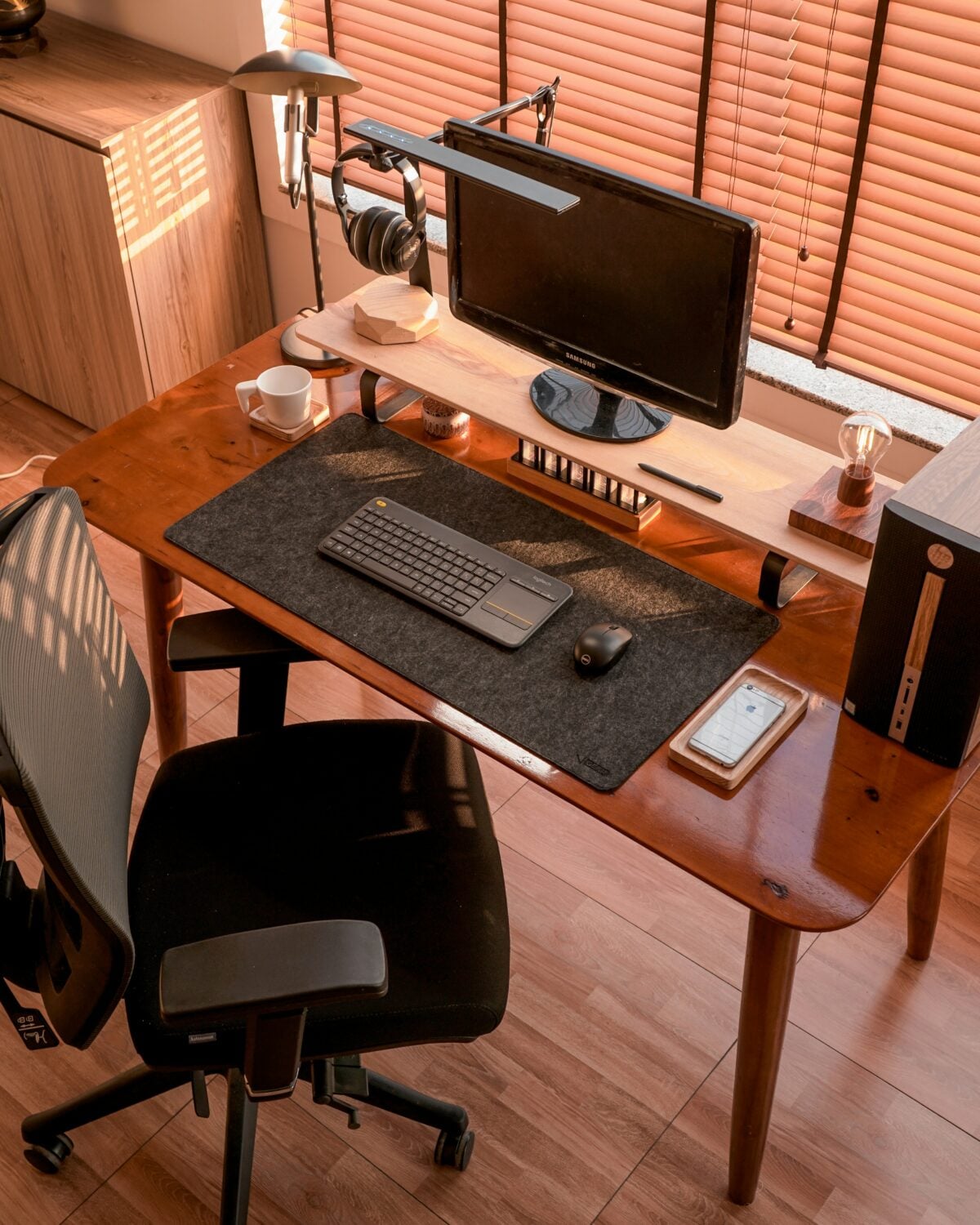 Everyday tech devices on a desk including phone, keyboard, and headphones