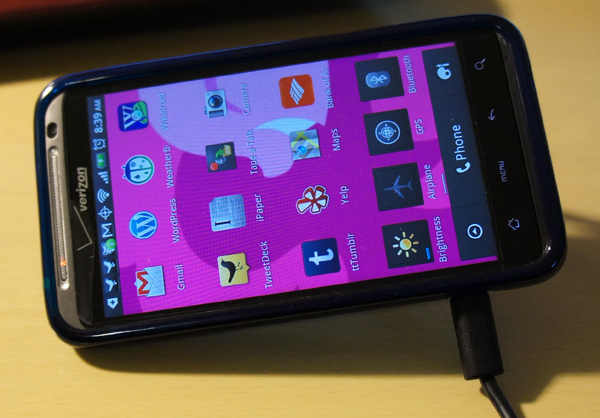 HTC Thunderbolt, kickstand out, USB cord plugged in